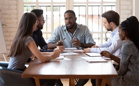 A diverse group of coworkers have a meeting