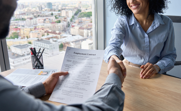 woman-shaking-hands-over-desk-after-hiring_1200x740.png